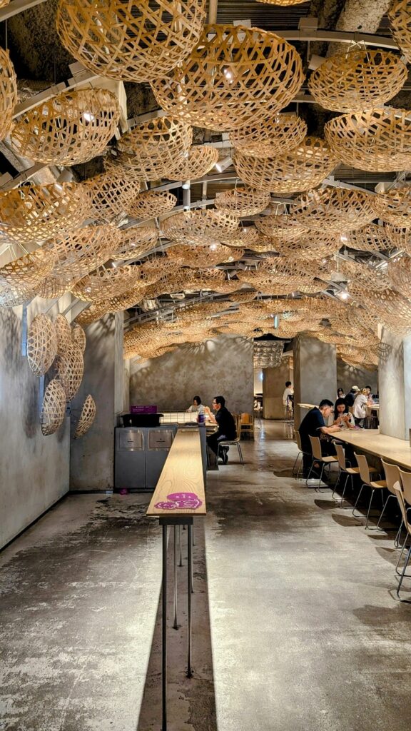 the inside of the trendy vegan-friendly donut shop Koe with a ceiling filled with wicker works of art 