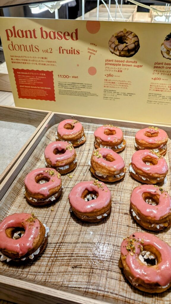 a tray of vegan donuts topped with a strawberry glaze at koe donuts in kyoto