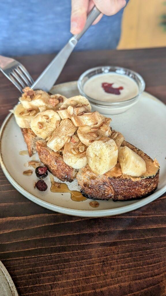 a thick slice of vegan toast covered with banana slices and maple syrup at veg out in kyoto