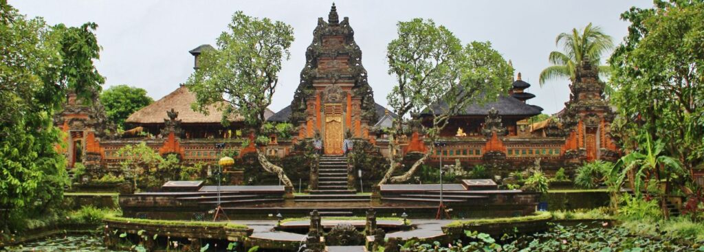 a temple in bali surrounded by lush green foliage and a pond in bali