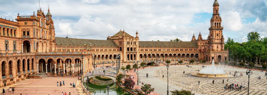 the plaza de espana with a few people walking around on a cloudy day in seville, spain