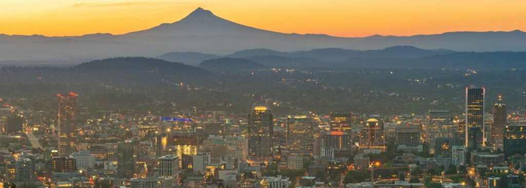 the orange sunset around mt hood with portland in the foreground