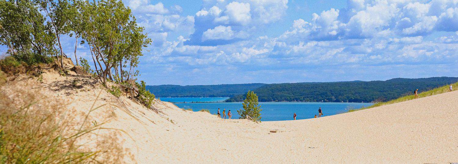 a dip in the sand at the sleeping bear sand dunes just outside of traverse city during the summer