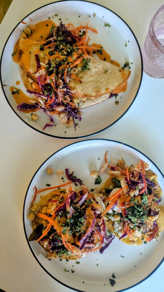 overhead shot with two colorful veggie mexican and puerto rican inspired tacos and fajitas at better food corps in san juan