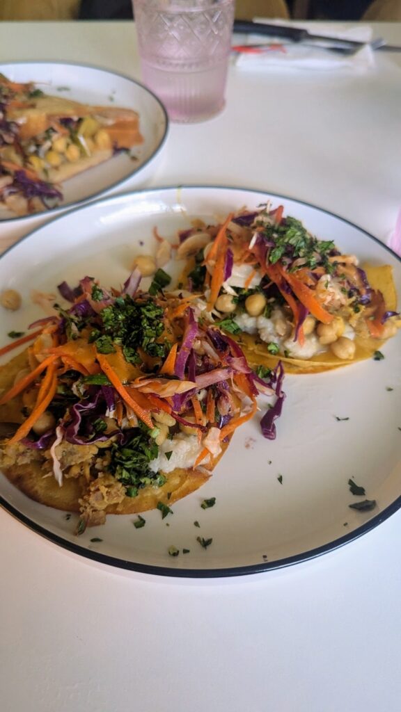 upclose shot of two vegan tacos with a colorful mix of veggies, garbanzo beans, and sauce at better food corps