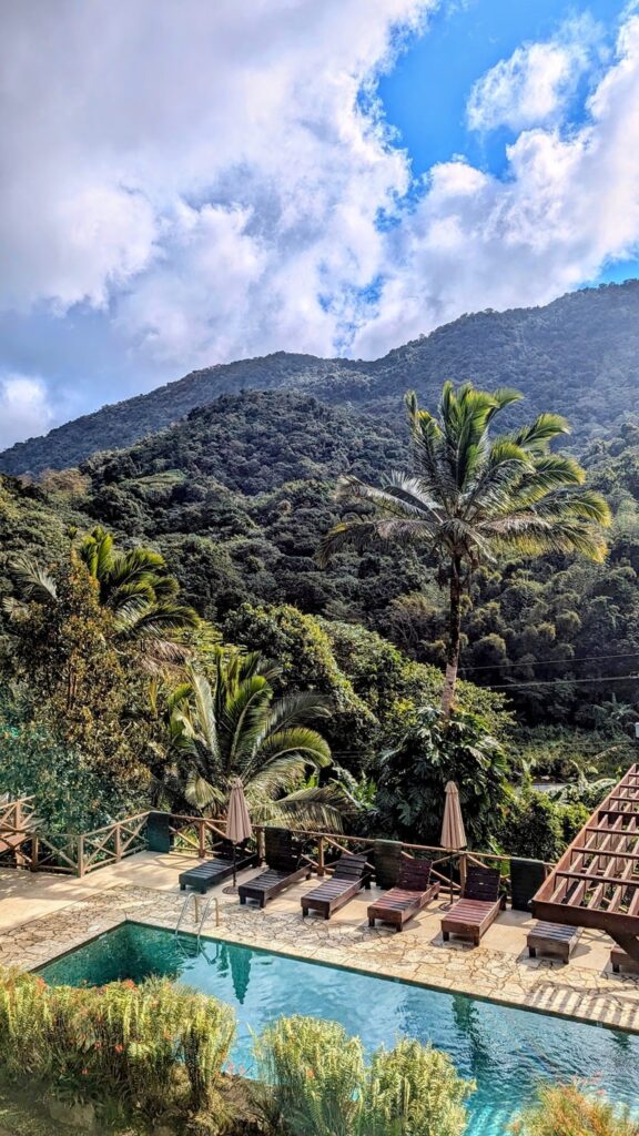 mountain view behind a salt water pool on a partly cloudy day at casa mountain retreat in puerto rico