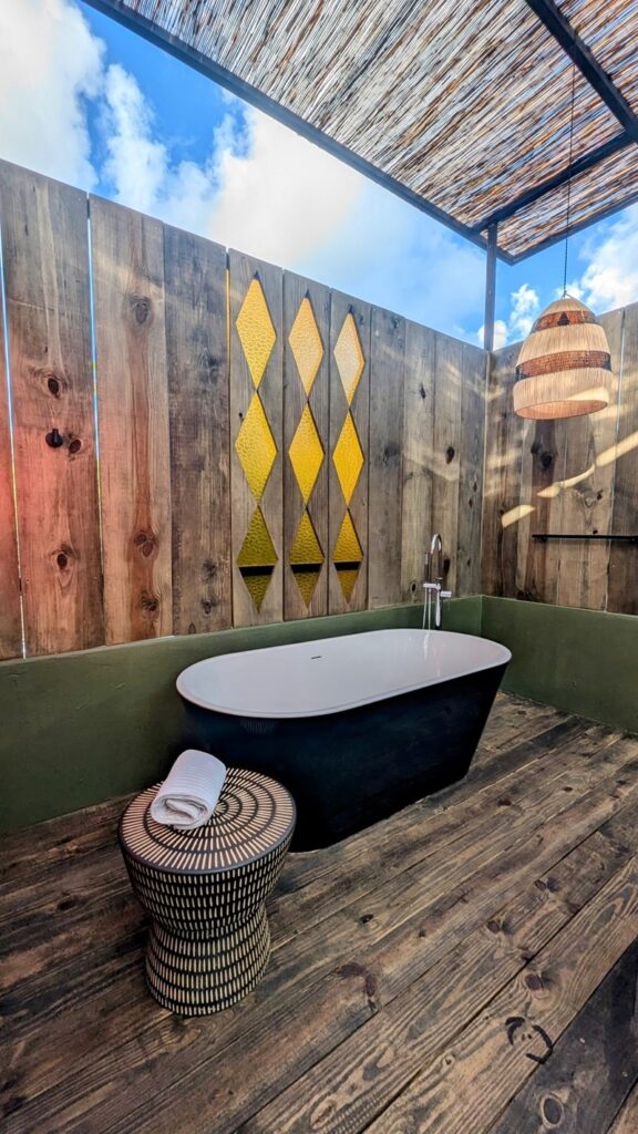 outdoor shower and bathtub in a guest room at the vegetarian hotel dreamcatcher in san juan puerto rico