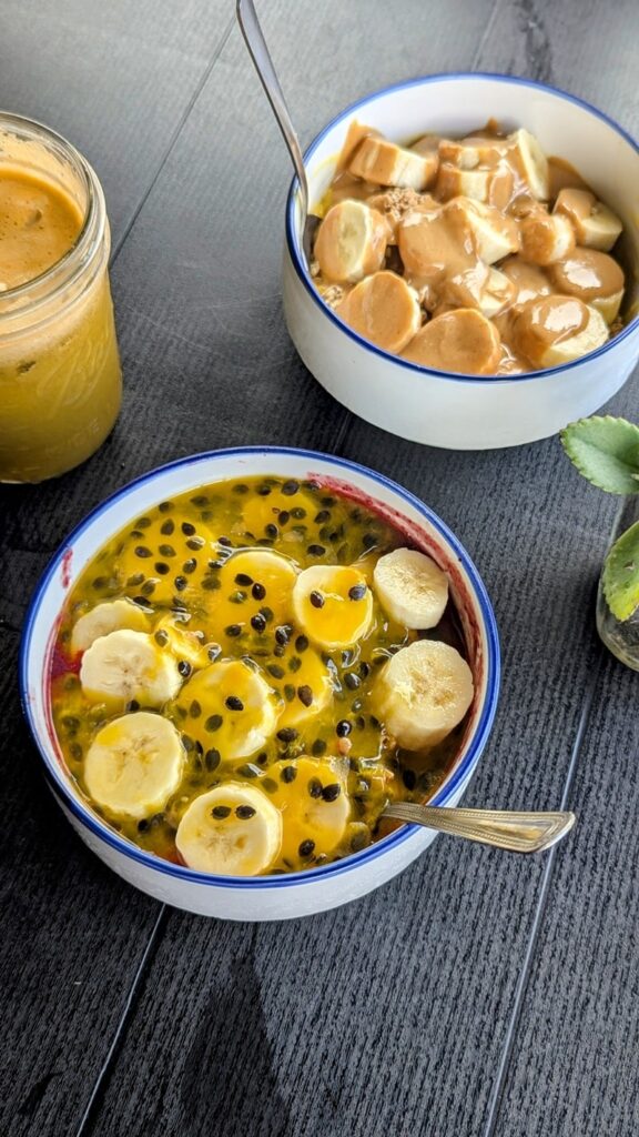 two smoothie bowls side by side topped with passion fruit puree, sliced bananas, and peanut butter in rio grande puerto rico