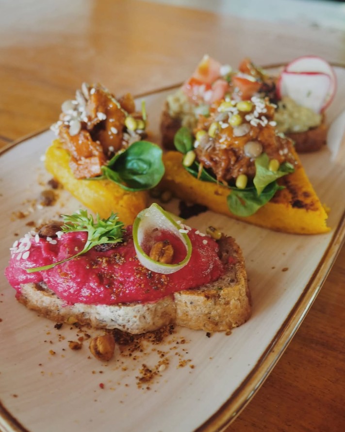 three slices of toast topped with colorful hummus at amaser in puerto viejo