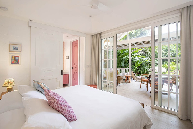 inside of a bright contemporary guest room with large windows at aguas claras in costa rica