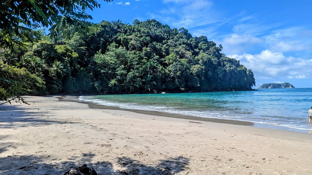 quiet white sandy beach at manuel antonio in costa rica on a sunny day