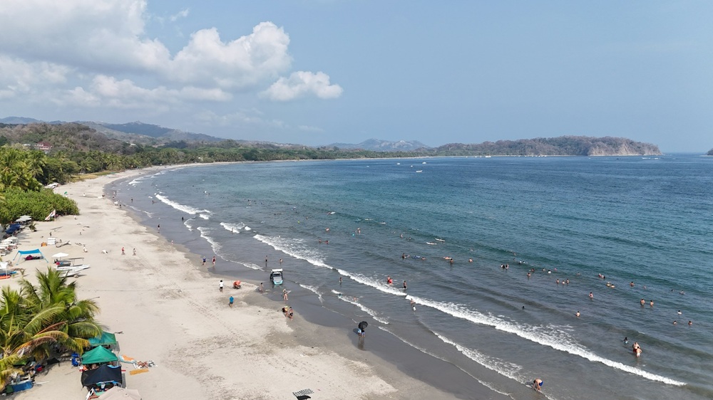 overhead view of the long white sandy beach in tamarindo costa rica