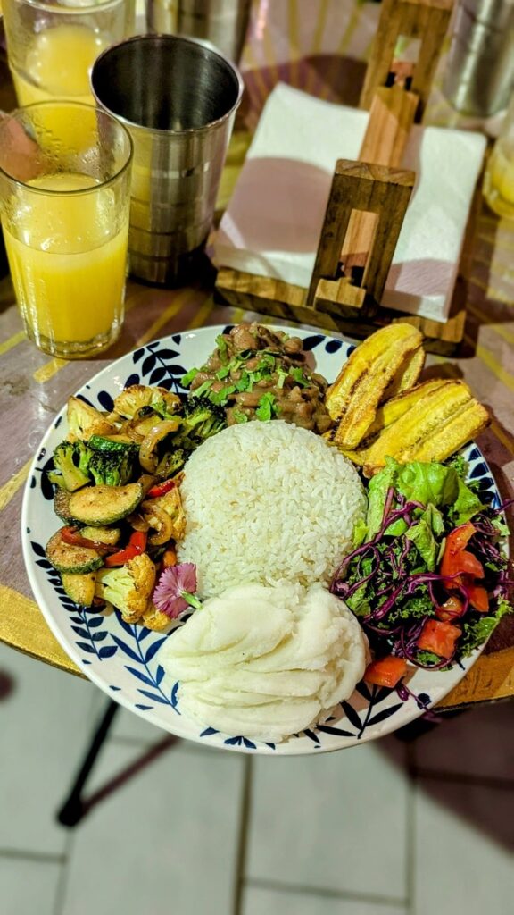 a large round bowl filled with rice and colorful veggies varuna plant based in manuel antonio in costa rica