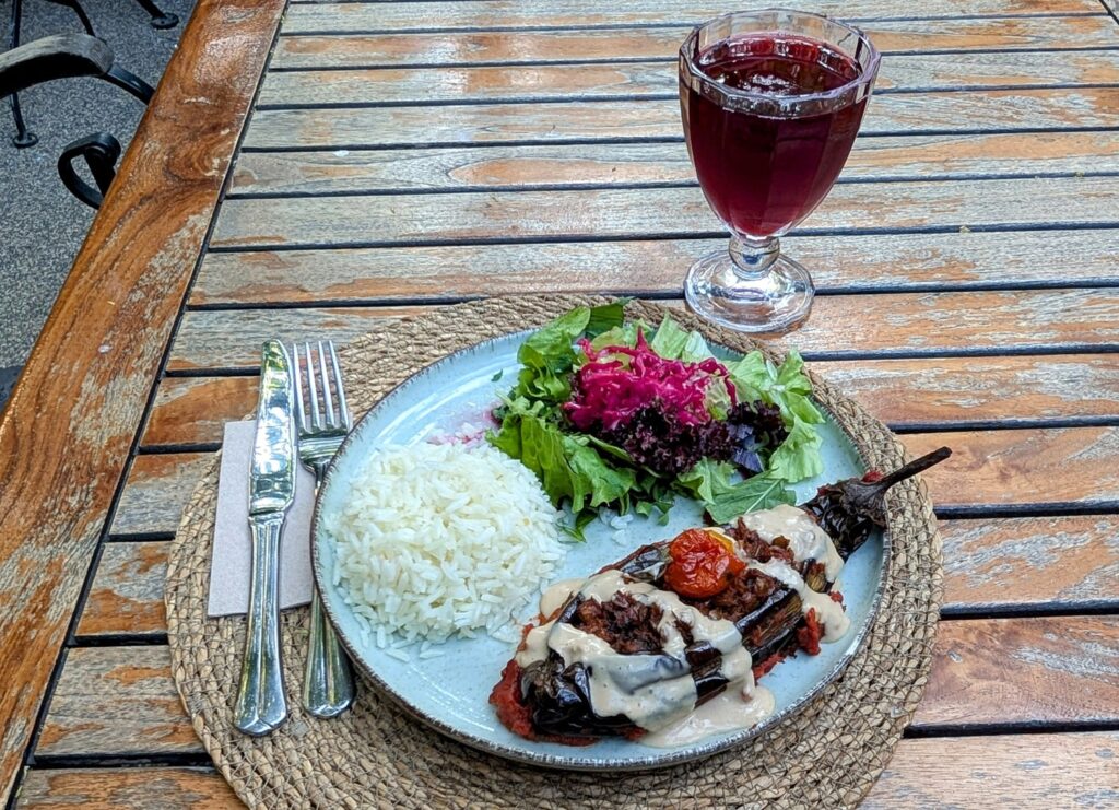 roasted eggplant with a tahini drizzle with a small salad and rice at Kumin Vegan Lezzetler in istanbul