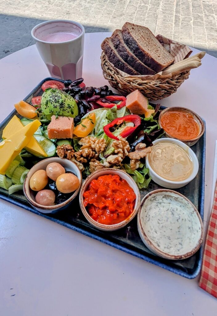 a vegan breakfast platter filled with veggies, tofu, cheese, beans, olives, and toast at Dükkan Galata in istanbul
