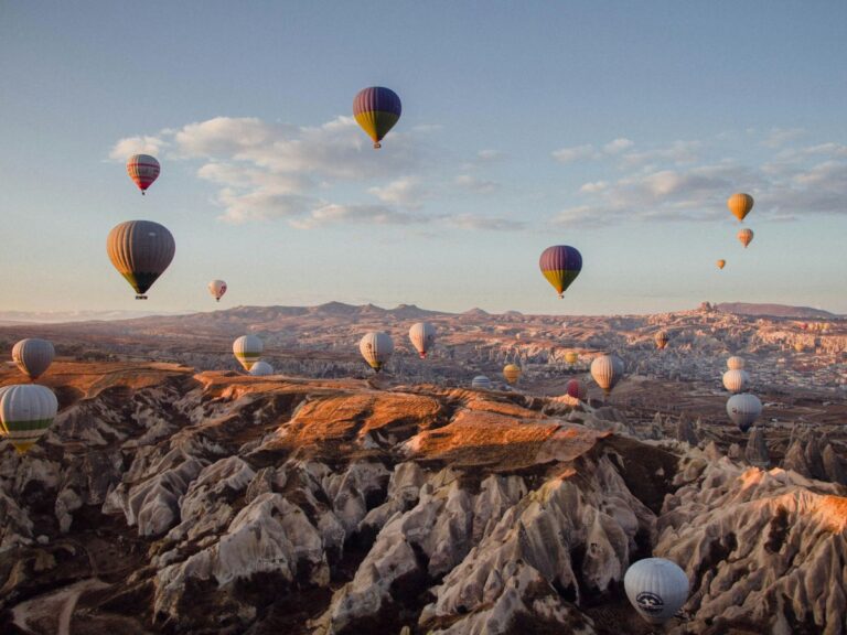 hot air balloons over the valley in cappadocia, turkey, at sunrise