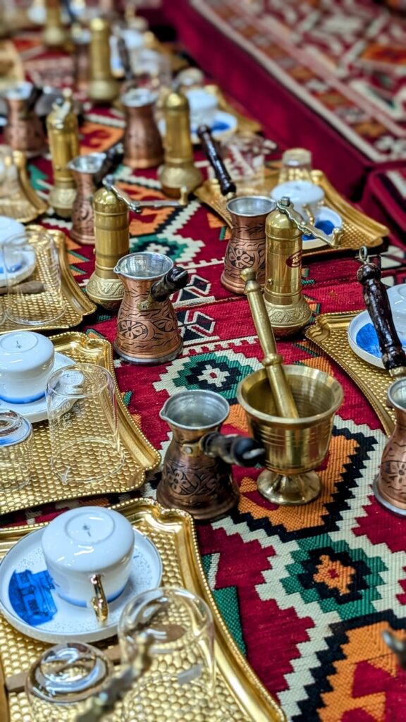 colorful setup for a turkish coffee making class with mini cups, grinders, and platters