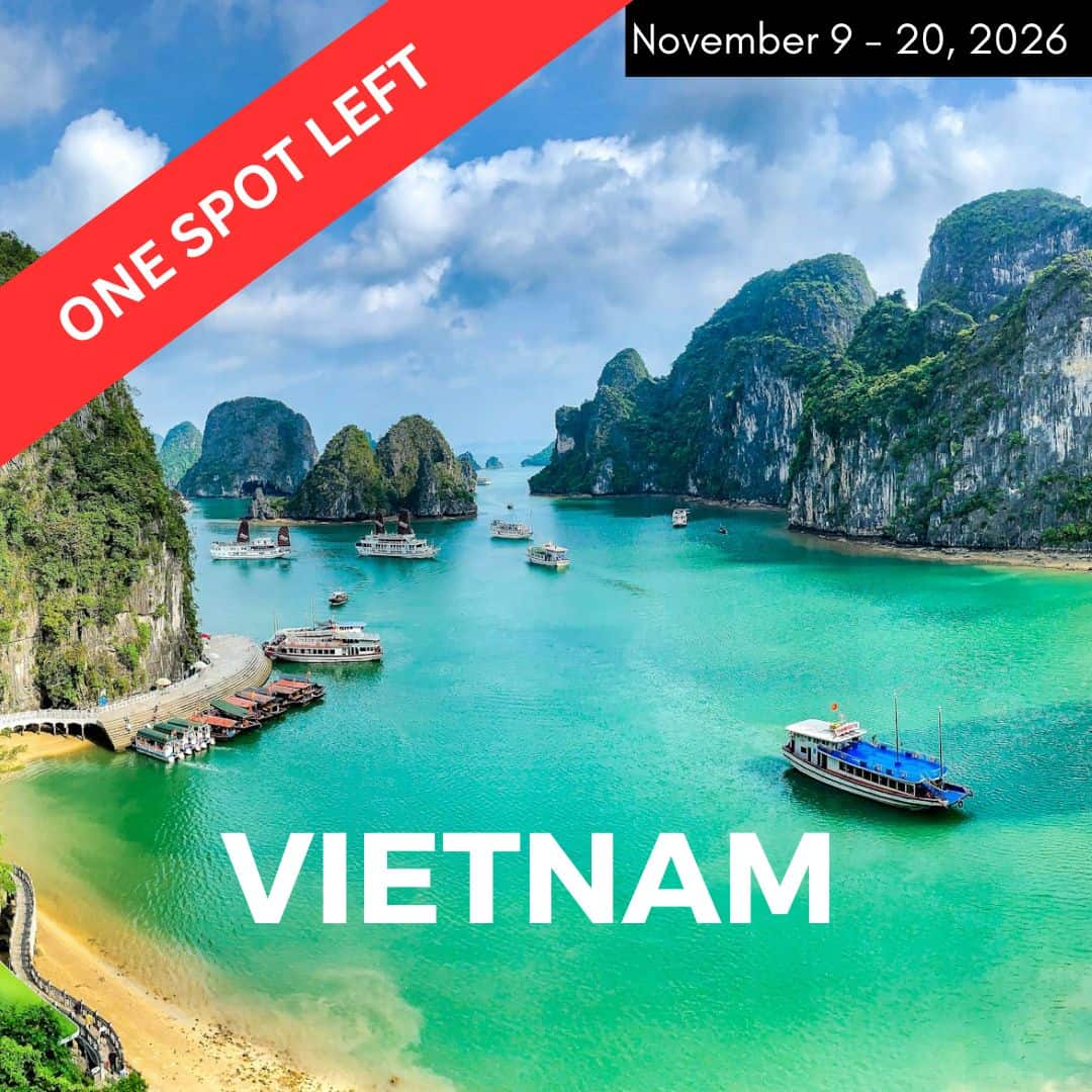 overhead view of the emerald green and blue halong bay with a few boats on a bright day in vietnam
