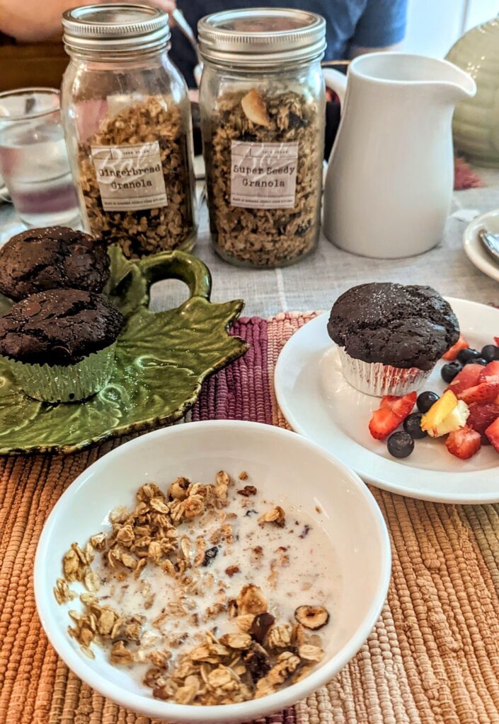 house made vegan chocolate muffins with multiple granola options and plant based milk on a table at black sheep inn 