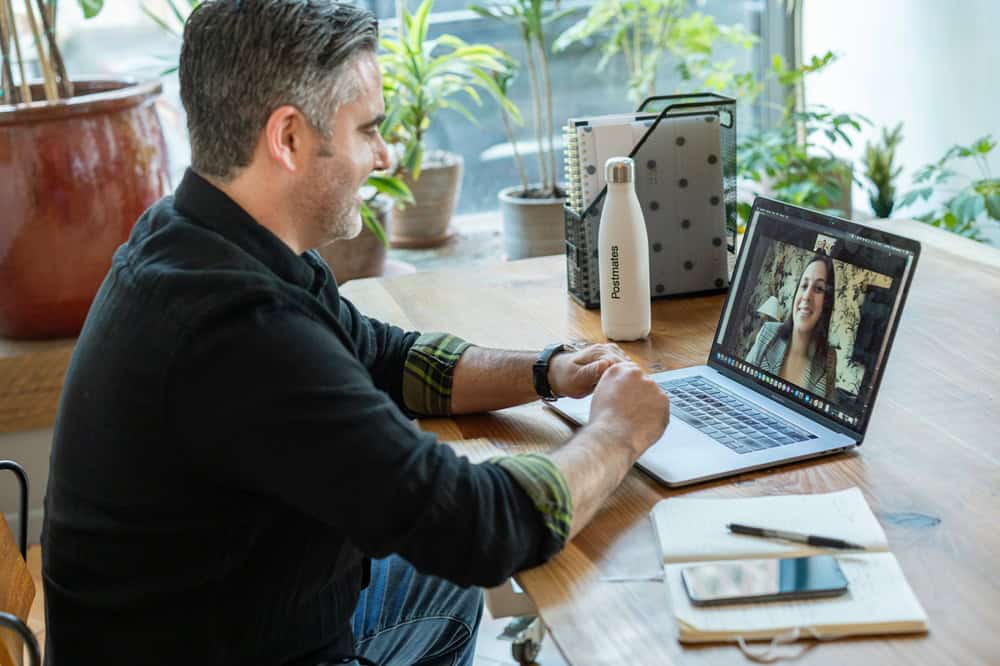 a man taking an online class from his laptop at home