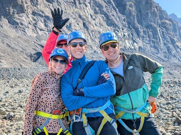 a group of four travelers posing on a glacier in iceland