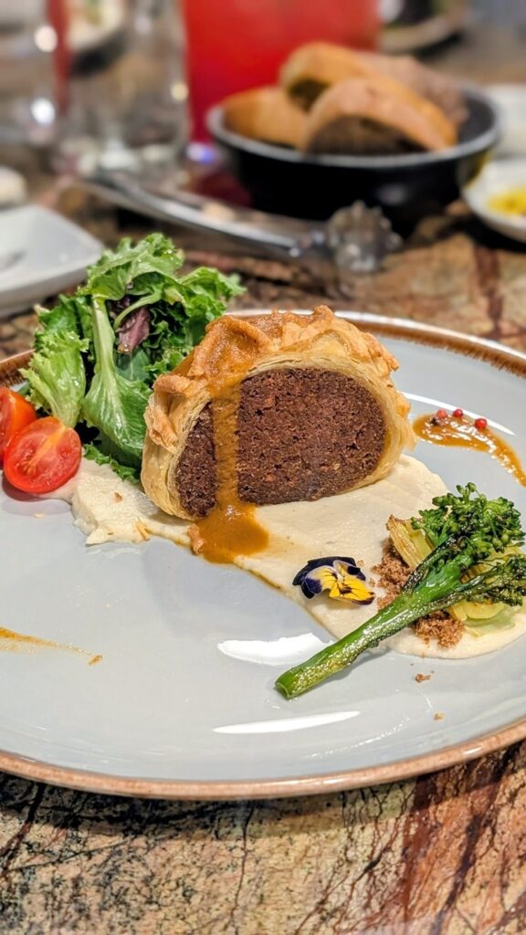 a vegan tofu wellington with broccolini and mixed greens at Jardineiro in porto