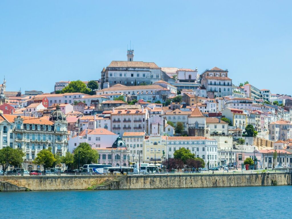 city view of coimbra from across the river on a partly cloudy day