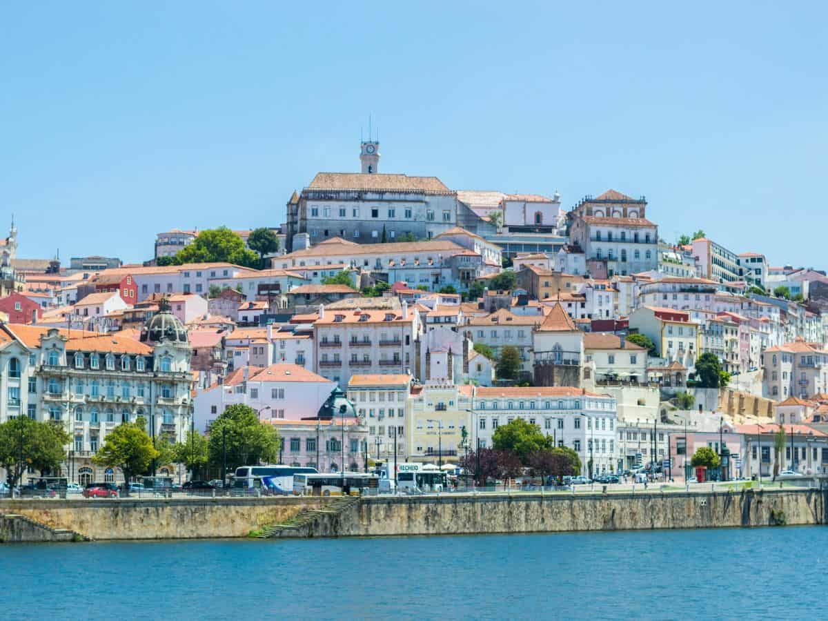 city view of coimbra from across the river on a partly cloudy day
