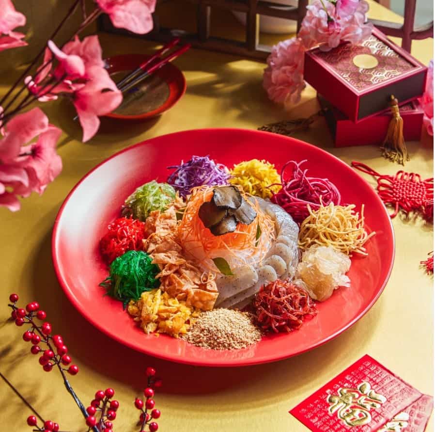 a red bowl filled with colorful plant-based ingredients from elemen in singapore