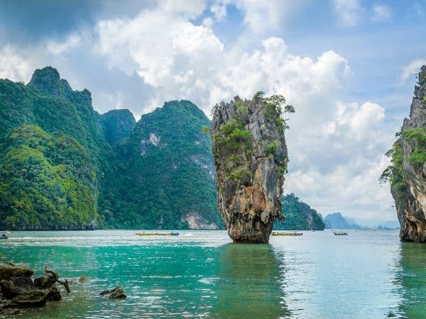 large rock formations jutting out of the turquoise water in thailand