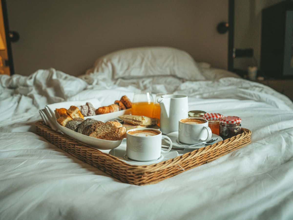 a wood tray with coffee, pastries and more for breakfast at a vegan hotel in paris