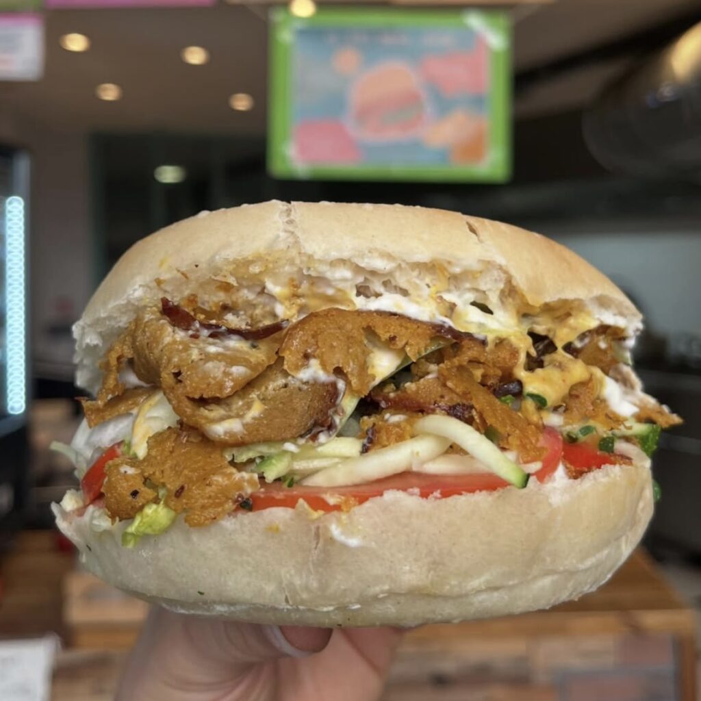 giant vegan sandwich with meat and a creamy sauce at gustavo in lyon