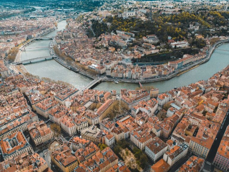 overhead shot of the red roofs in lyon with the river running through the town