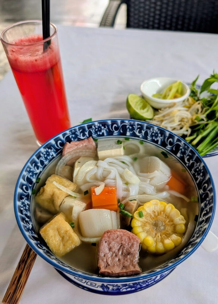 bowl of vegan Vietnamese noodle soup with tofu and corn chunks in Phnom Penh