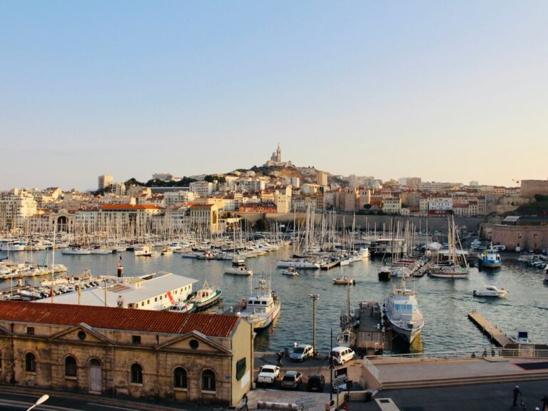 over head shot of the harbor in marseille france filled with boats as the sun is setting