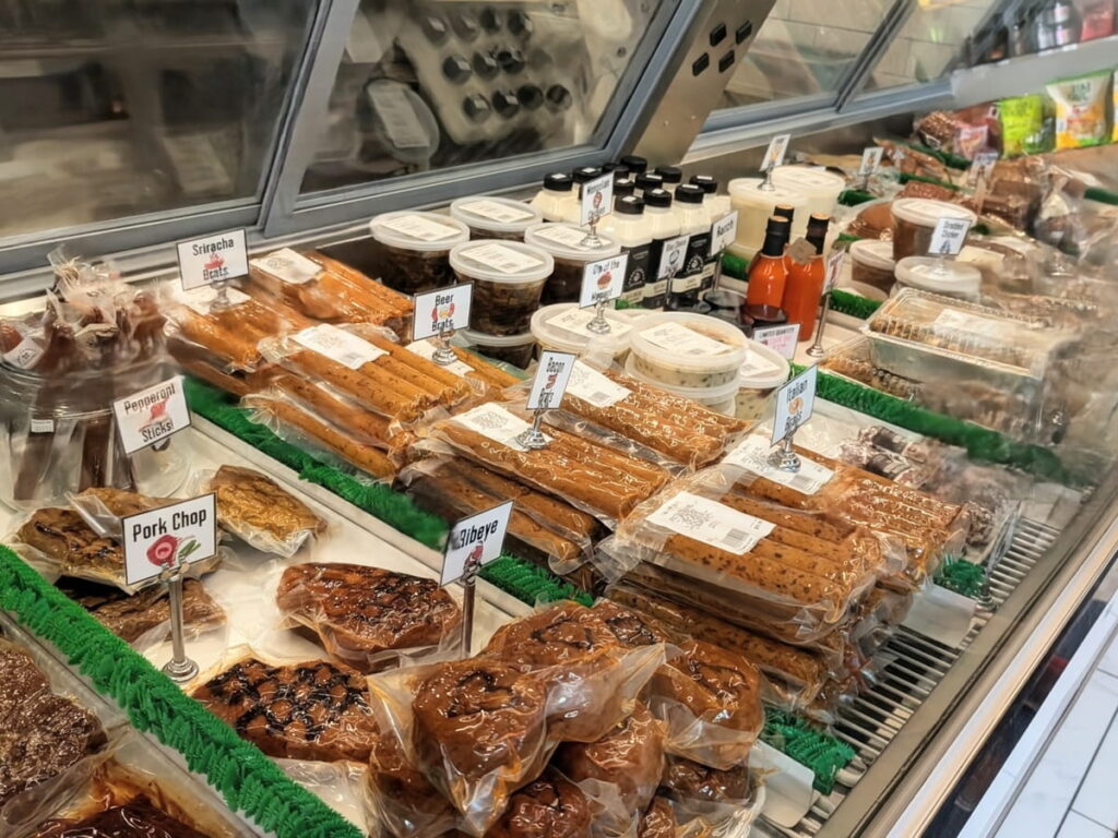 inside of the vegan meat counter with rows of sausages, deli meats, and cheeses at The Herbivorous Butcher in minneapolis