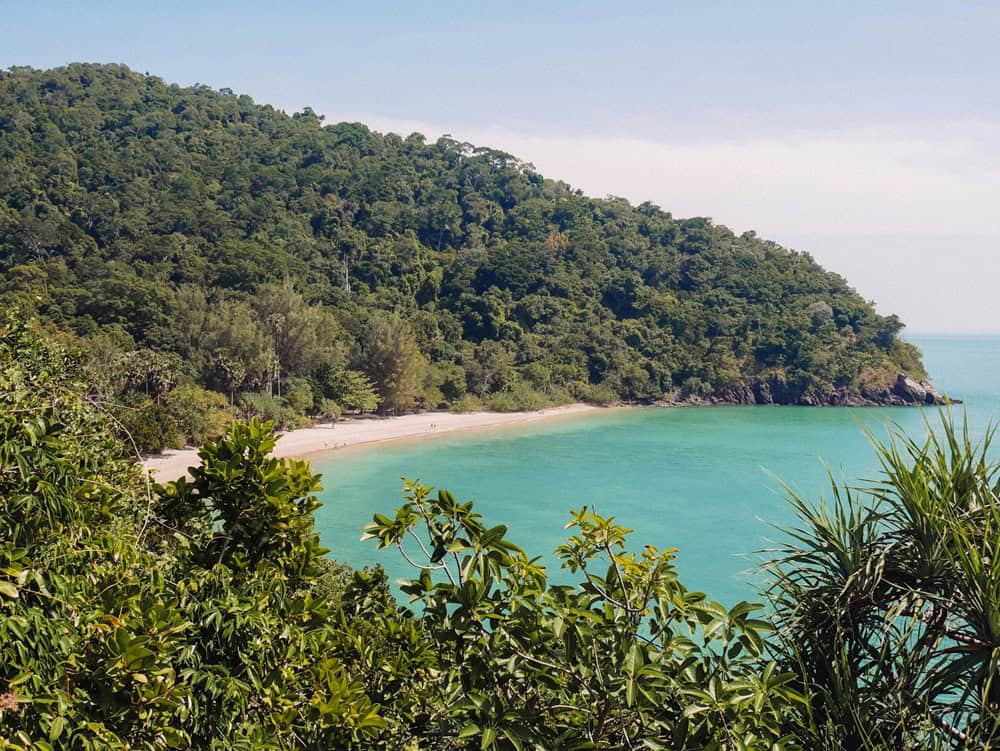 beautiful secluded beach surrounded by lush green forest on koh lanta in thaniland