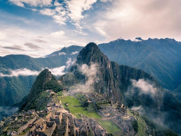clouds surrounding the mountains around machu picchu in peru