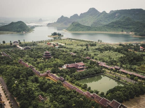 overhead shot of a misty morning in nihn bihn with lush green fields and water