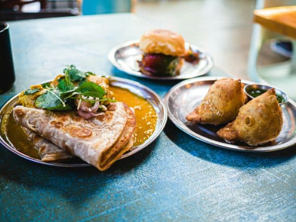 multiple vegan indian dishes spread across a table