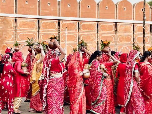 women wearing bright red sari outfits in india