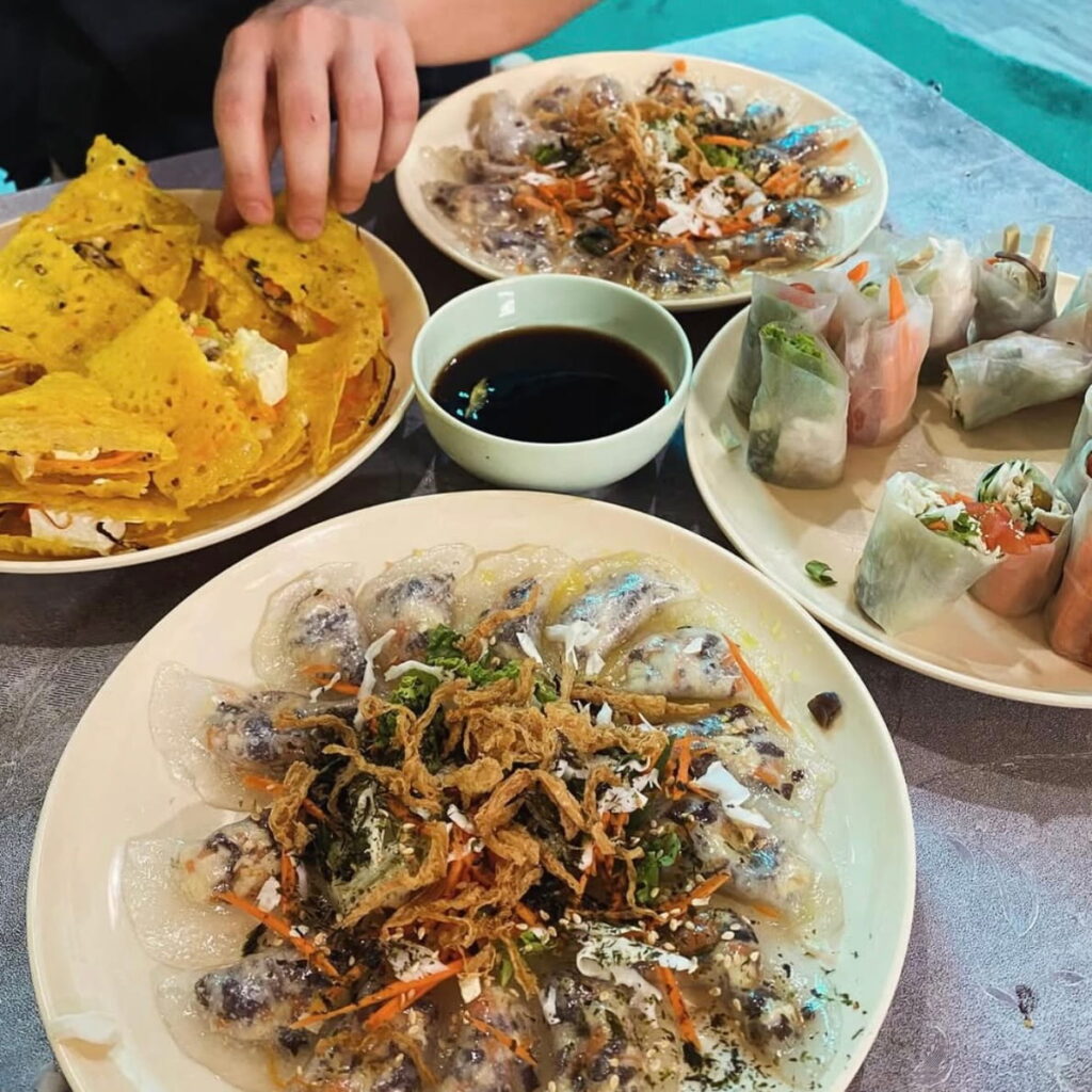 multiple vegan dishes spread across a table at chay corner in hoi an