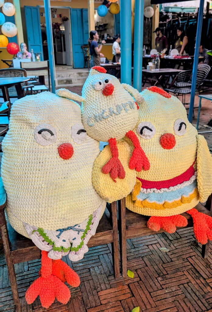 three giant stuffed chicks in front of the vegan cooking school and restaurant chickpea in hoi an