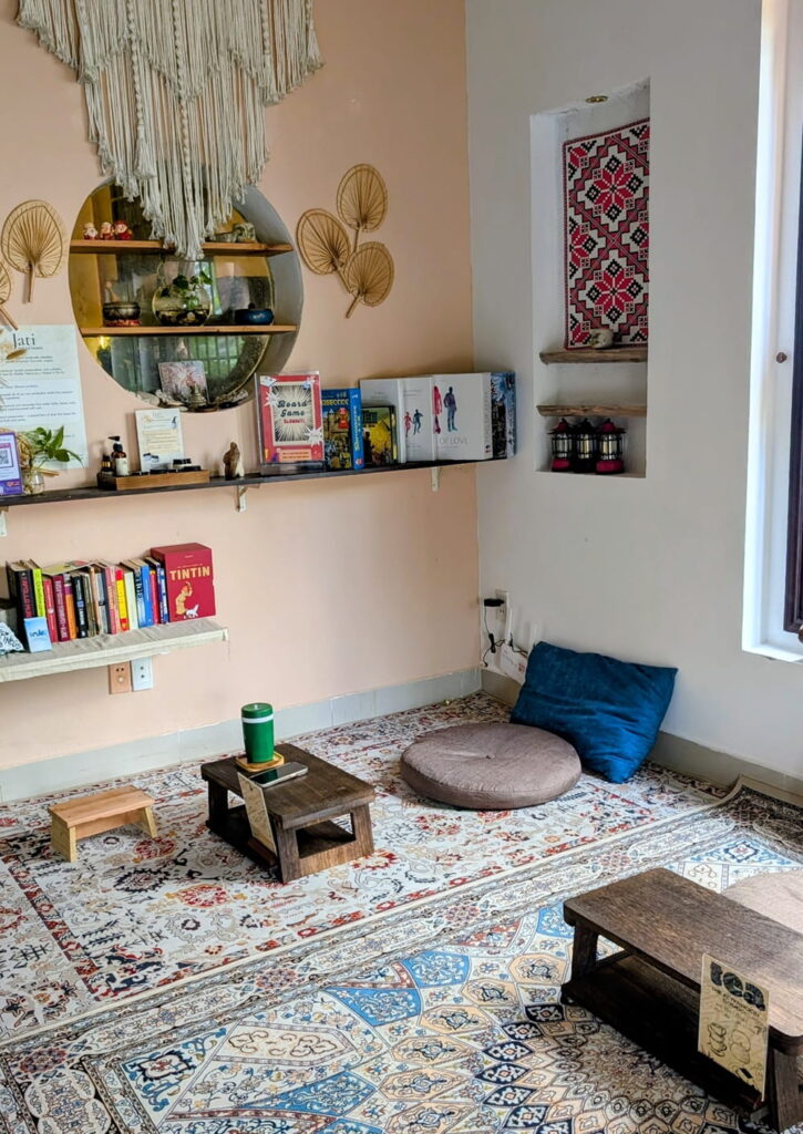 the cozy and calming seating area with pastel colors and crocheted wall decor at plant lab in hoi an
