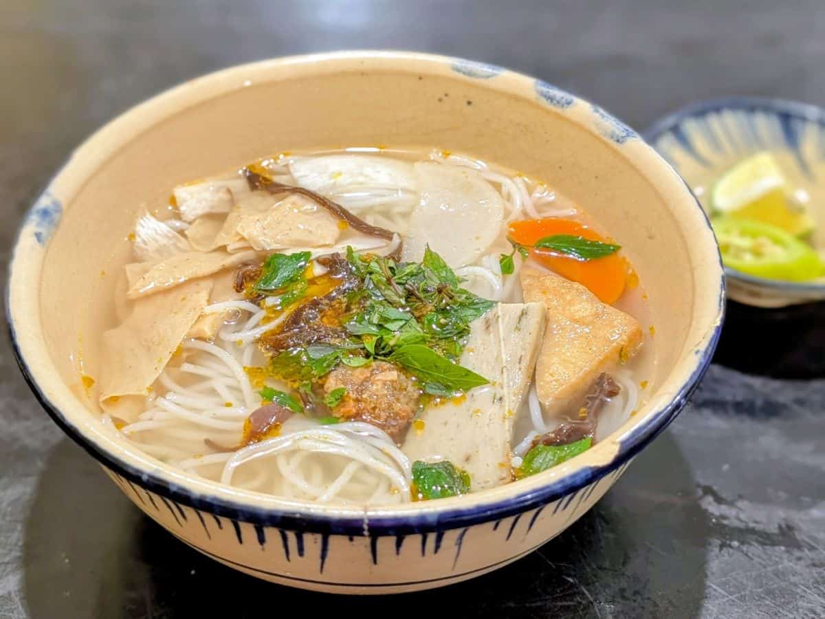 a large bowl of vegan tofu noodle soup at Mộc Lâm An Vegan in hoi an