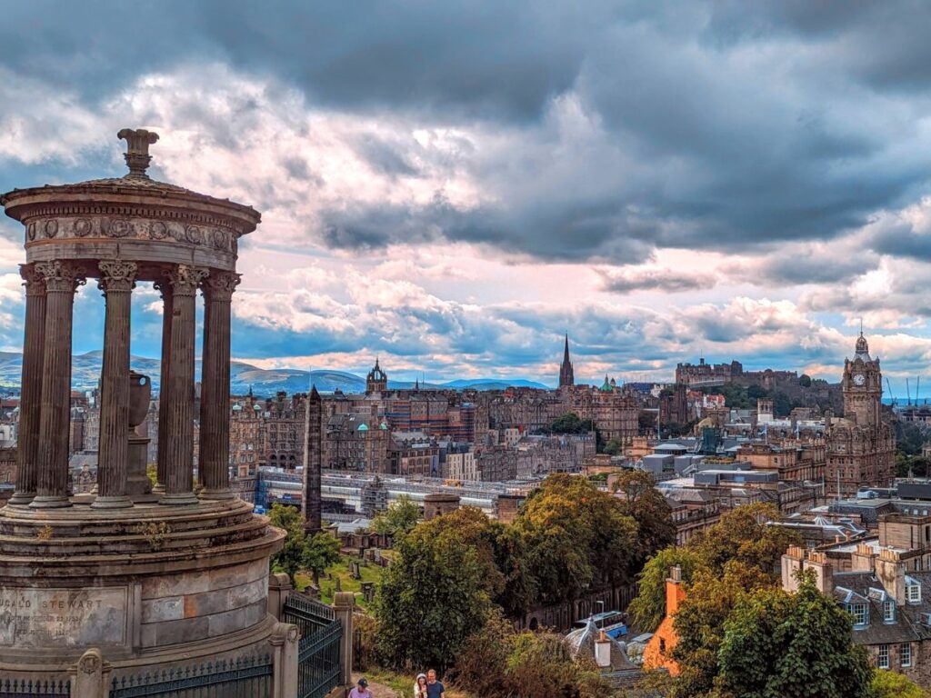 the overhead view of edinburgh with a cloudy sky as the sun is setting