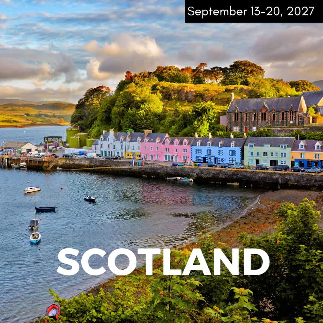 colorful buildings right on the ocean as the sun is setting in scotland