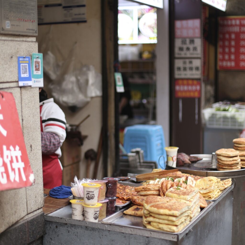 Vegan Chinese pancakes at a bustling street food stall in Shanghai.