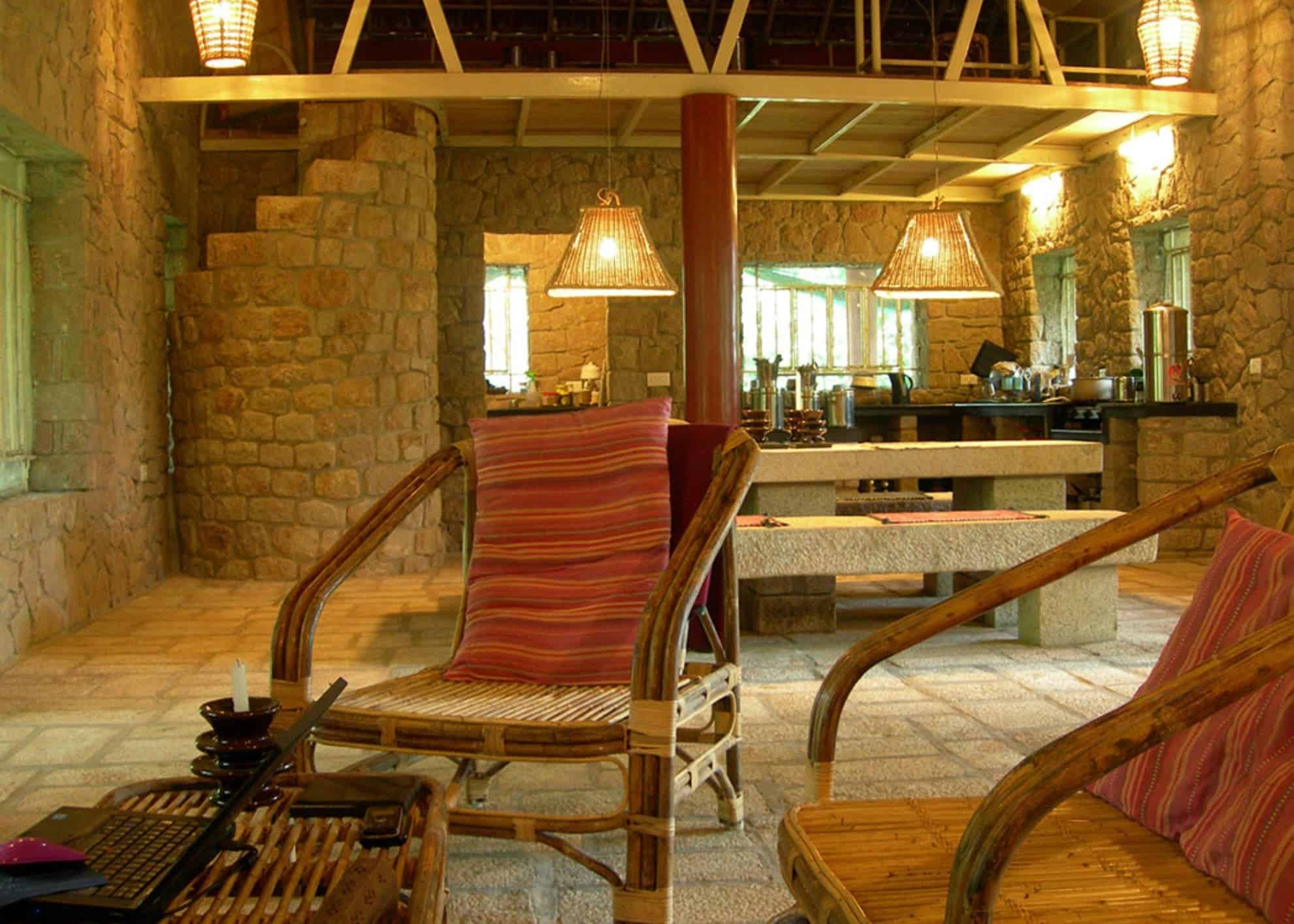 Rustic stone interior and dining area at Indhrivanam in Thekkady, Kerala