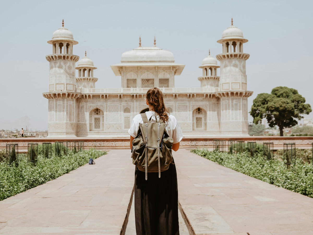 Traveler with a backpack visiting historic architecture in India